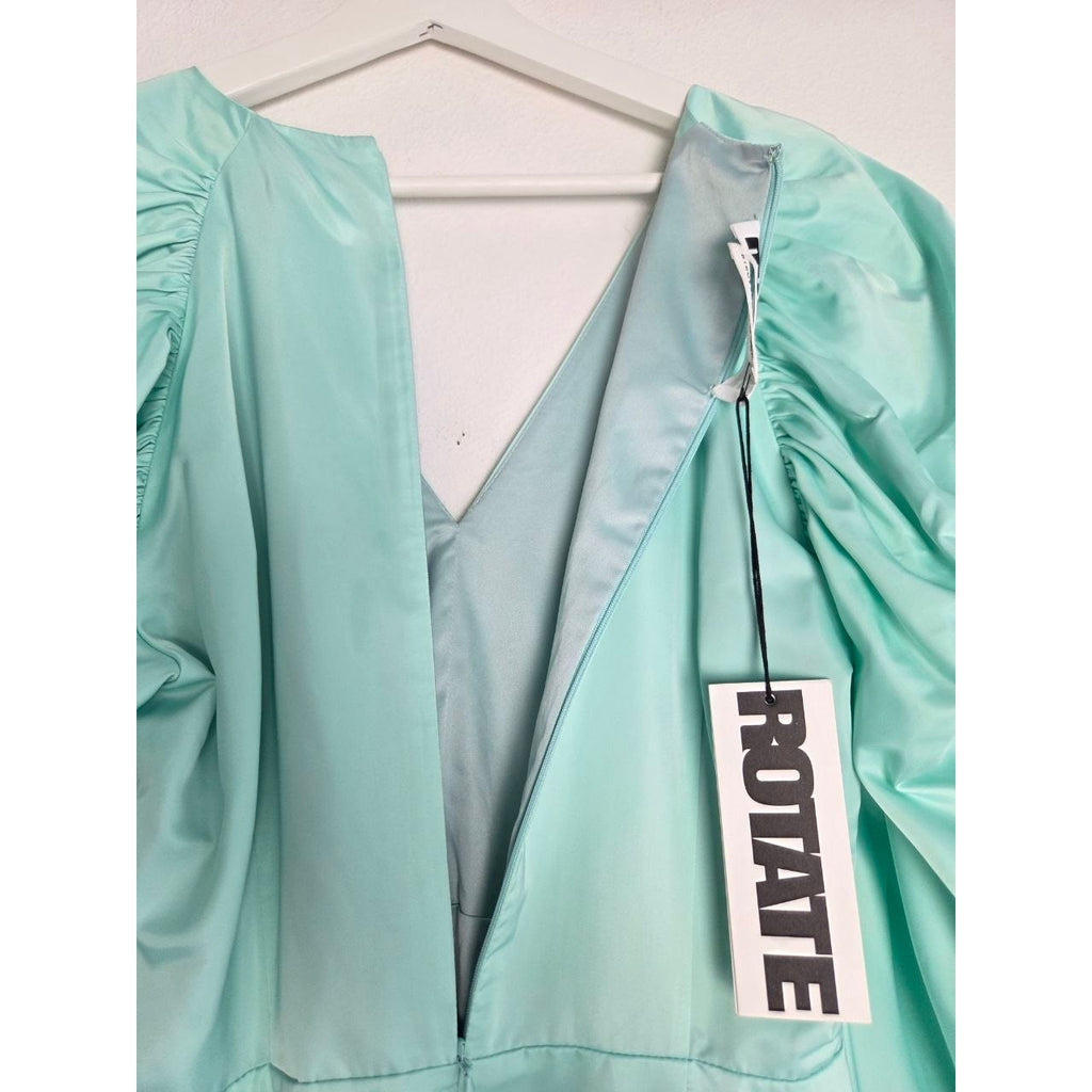 Neckline and attached hangtags of ROTATE Morning Mist aqua mini dress