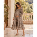 Model wearing the Frances Hart Maxine taupe floral maternity dress with a smocked bodice and tiered skirt