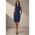Model wearing a blue and black Derek Lam sleeveless sheath dress with side pockets