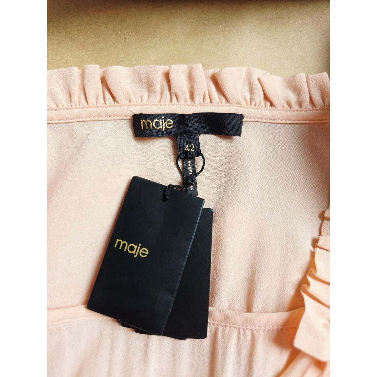 Brand label and attached hangtag of Maje Riava blush mini dress