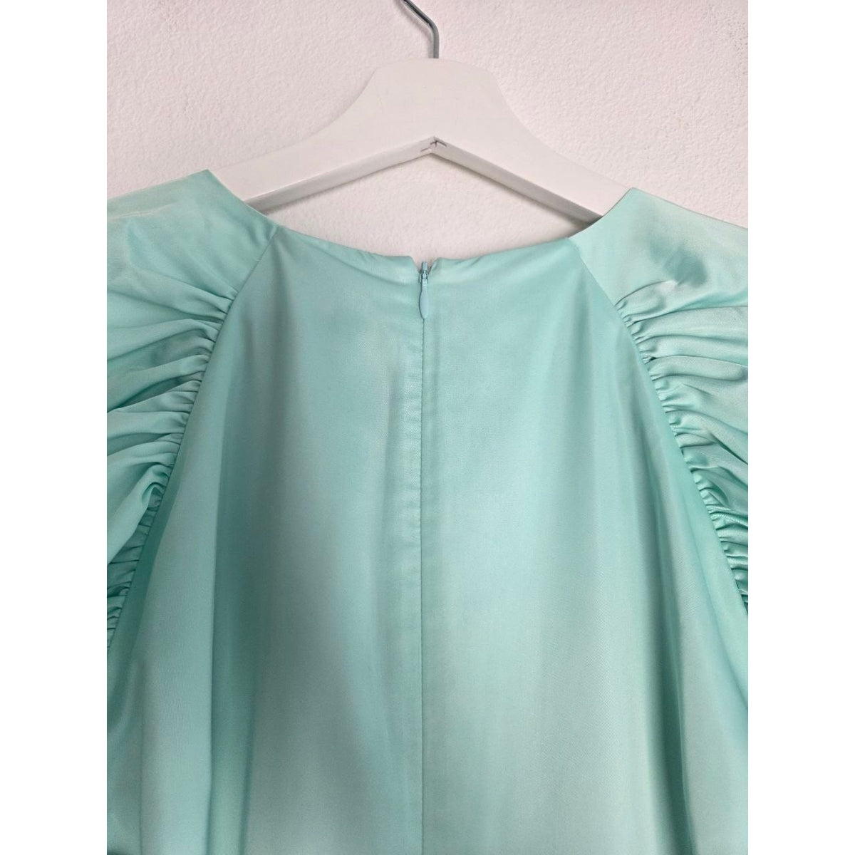 Back neckline and zipper of ROTATE Morning Mist aqua mini dress