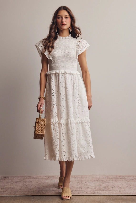 Front view of model wearing dress of white cotton eyelet midi dress