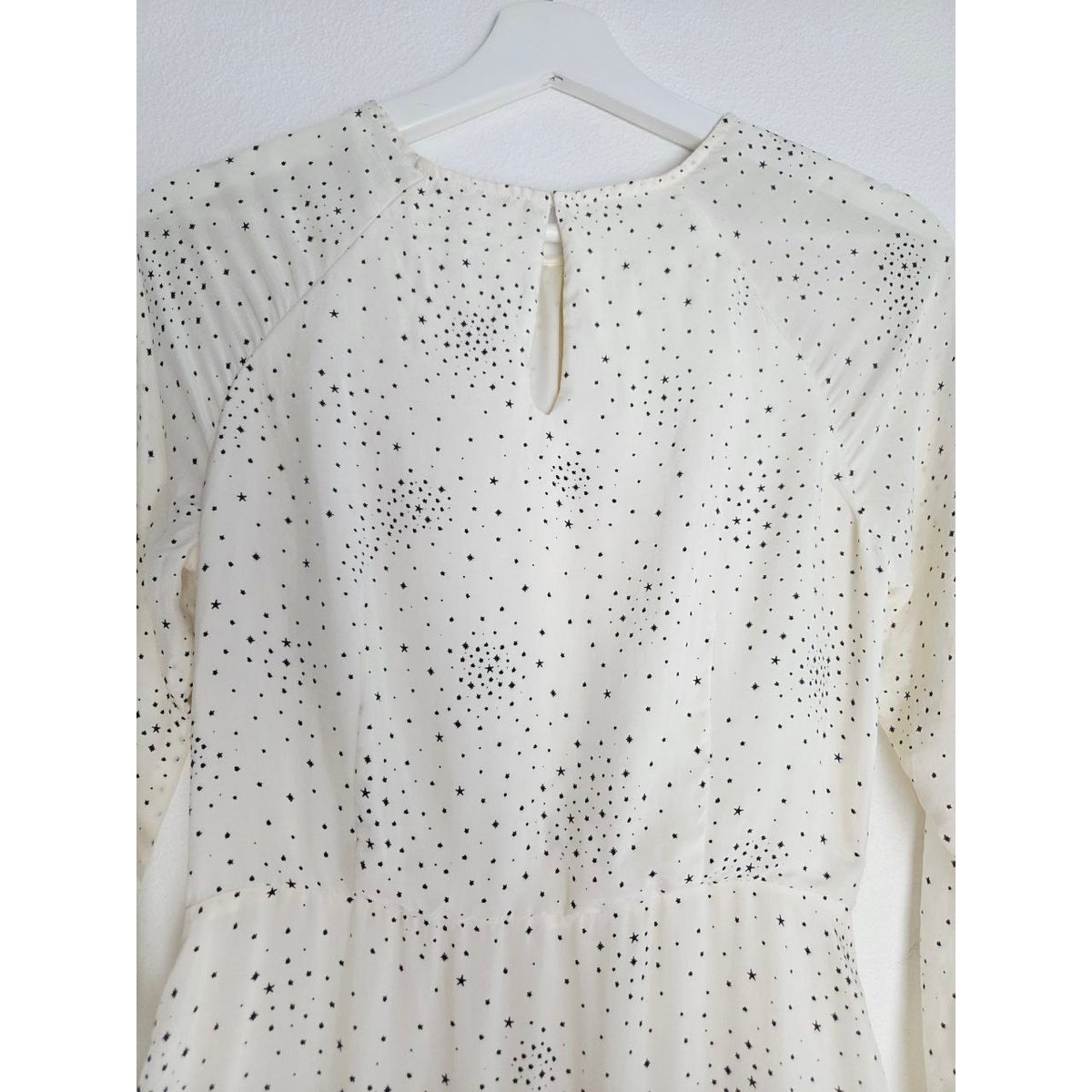 Back neckline and bodice of Maje Reto ecru star-print dress