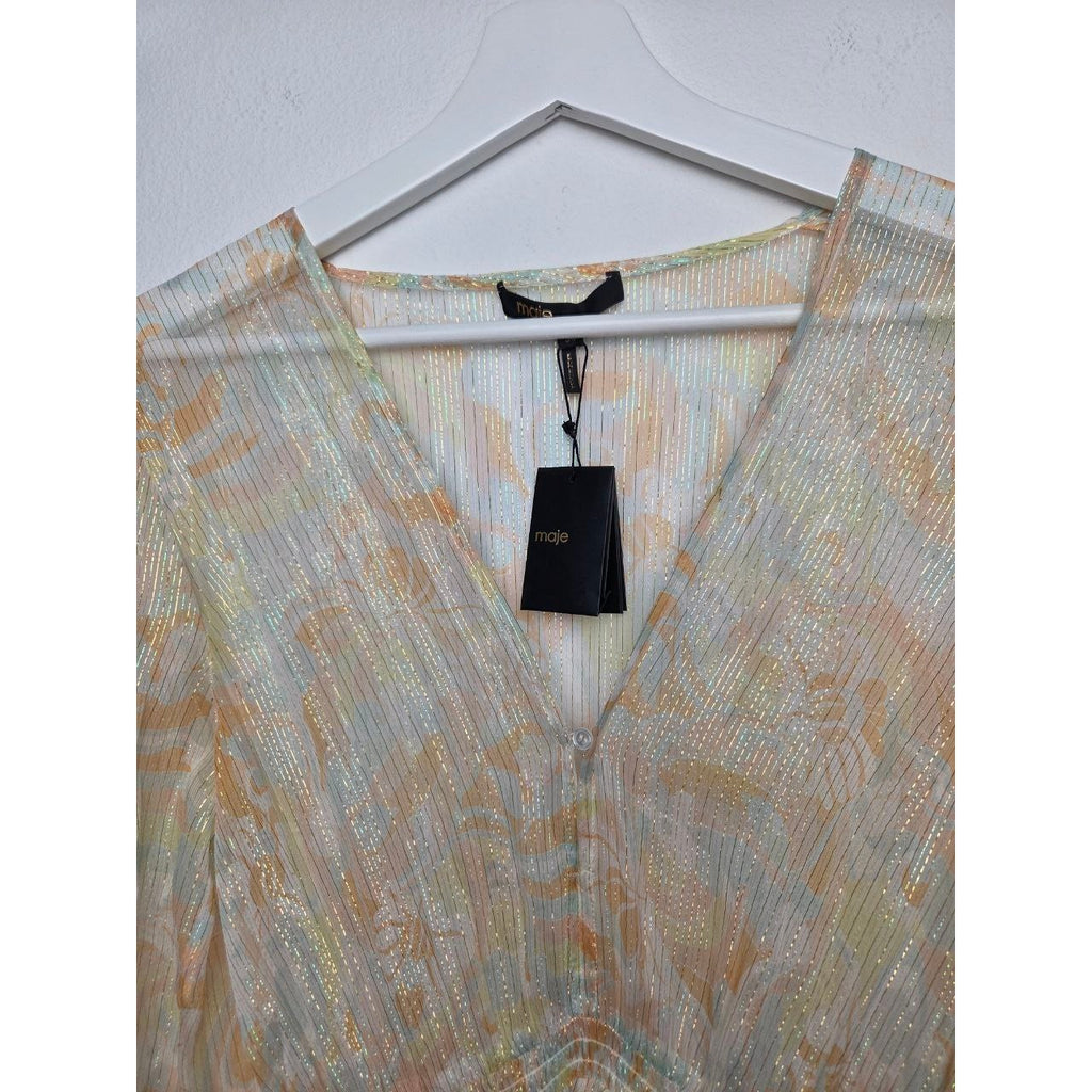 V-neckline and attached hangtag of Maje Rufflino metallic silk-blend maxi dress