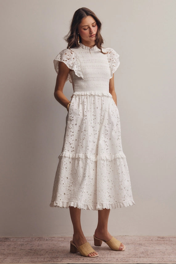 Front view showing smocked bodice of white cotton eyelet midi dress