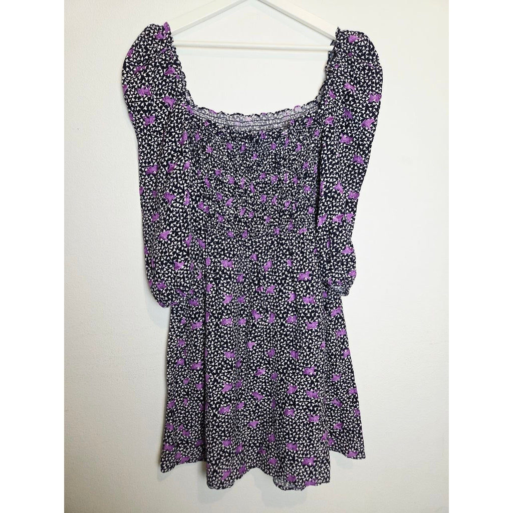 Back view on hanger of Maje Rappa floral smocked mini dress