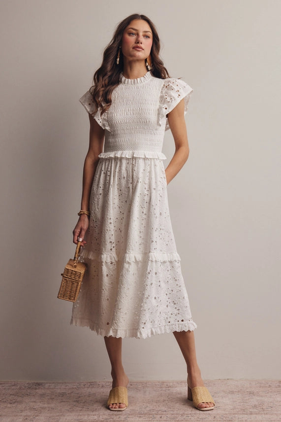 Model wearing dress, front view with handbag of white cotton eyelet midi dress
