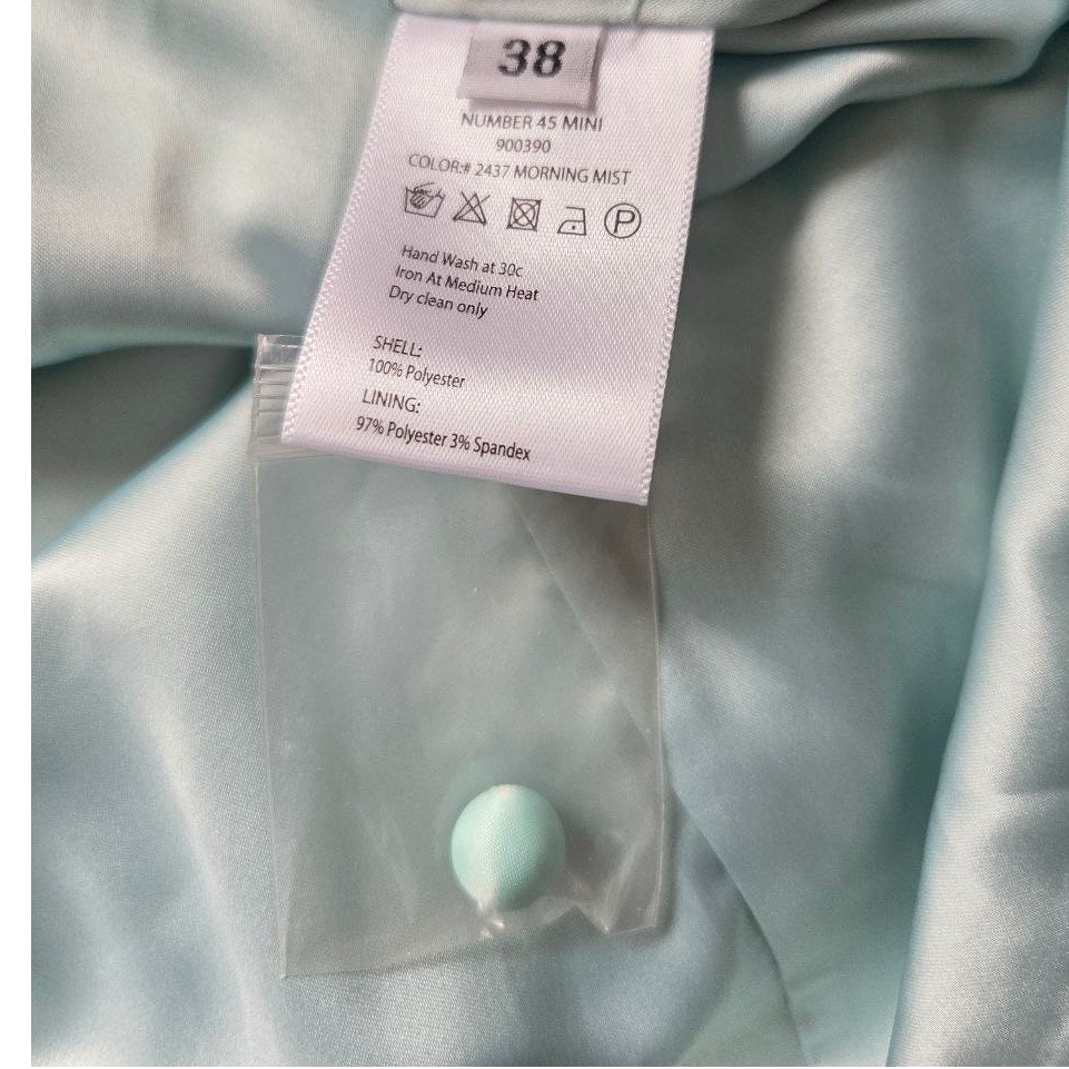 Size and care labels with spare button of ROTATE Morning Mist aqua mini dress