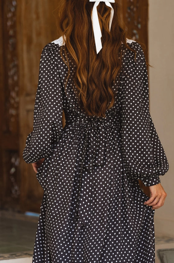 Back bodice and sleeve detail of black polka dot midi dress with lace collar