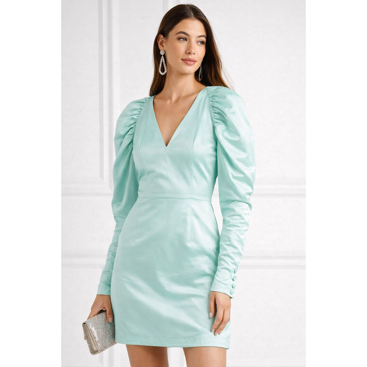 Model wearing a Morning Mist aqua ROTATE mini dress with a deep V-neck and long puff sleeves