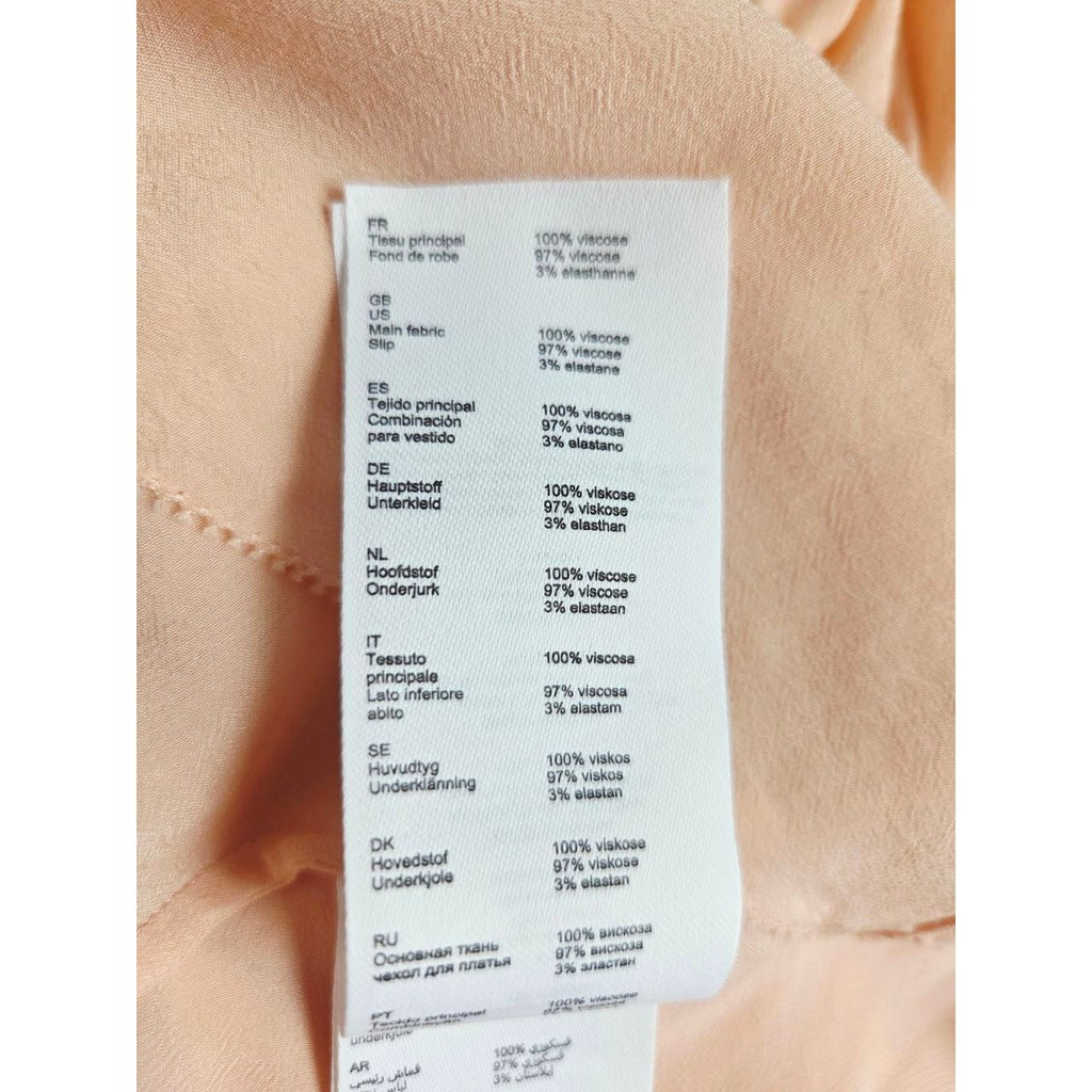 Composition label of Maje Riava blush mini dress