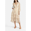 Model wearing the pastel Maje Rufflino silk-blend maxi dress with long sleeves and tiered ruffles
