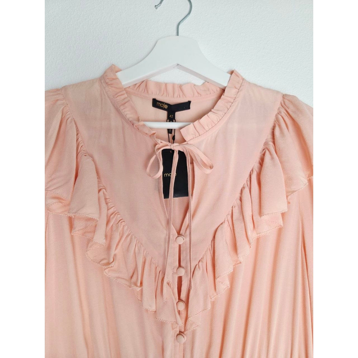 Tie neckline and ruffled bib of Maje Riava blush mini dress